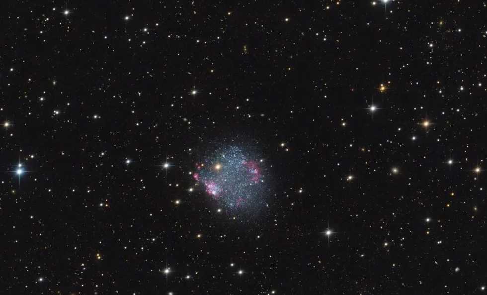 Sextans A: The Cosmic Underdog Where Stars Bloom in Ambery Clusters